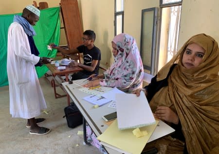 A man attends voting at a polling station during presidential election in Nouakchott