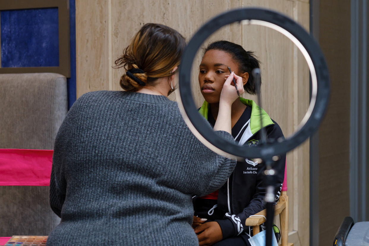 Imani Johnson has her makeup done at a competition. (Arvin Temkar for NBC News)