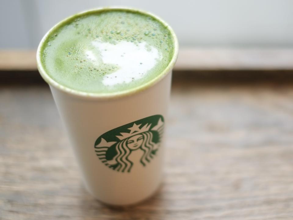 matcha latte from starbucks sitting on a wooden surface