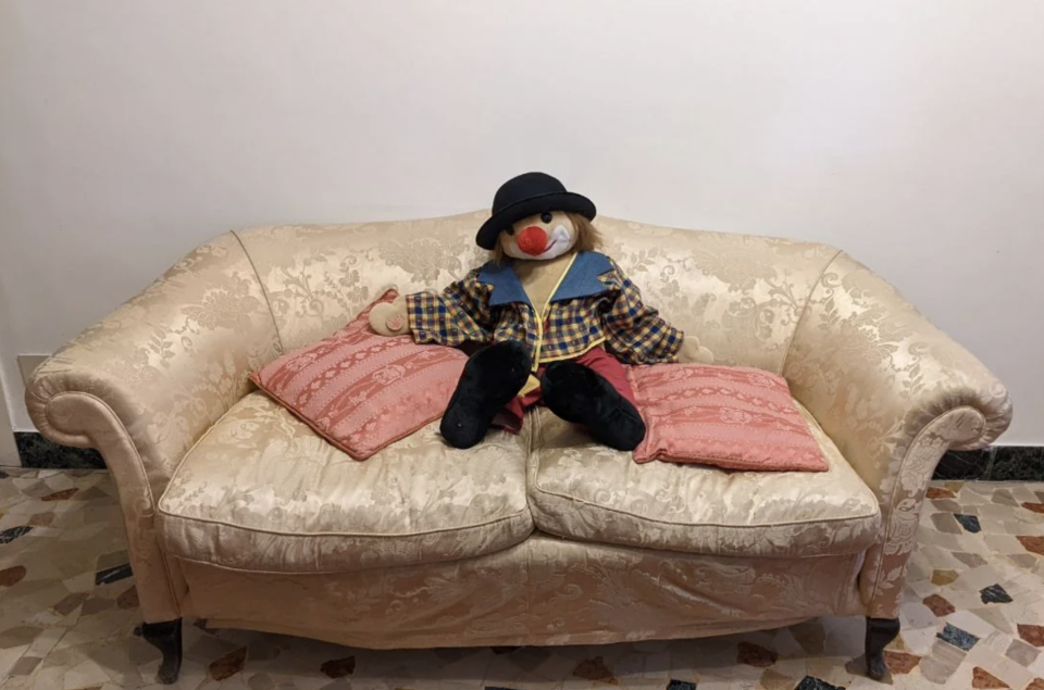 clown doll on a sofa