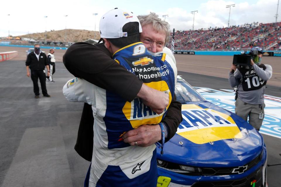 Chase Elliott hugs his father Bill Elliott after winning the season championship during a NASCAR Cup Series auto race at Phoenix Raceway, Sunday, Nov. 8, 2020, in Avondale, Ariz. Bill is also a former series champion. (AP Photo/Ralph Freso)