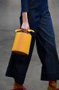 <p>A model carries a small, yellow bucket bag from the Ulla Johnshon FW18 show. (Photo: Getty Images) </p>