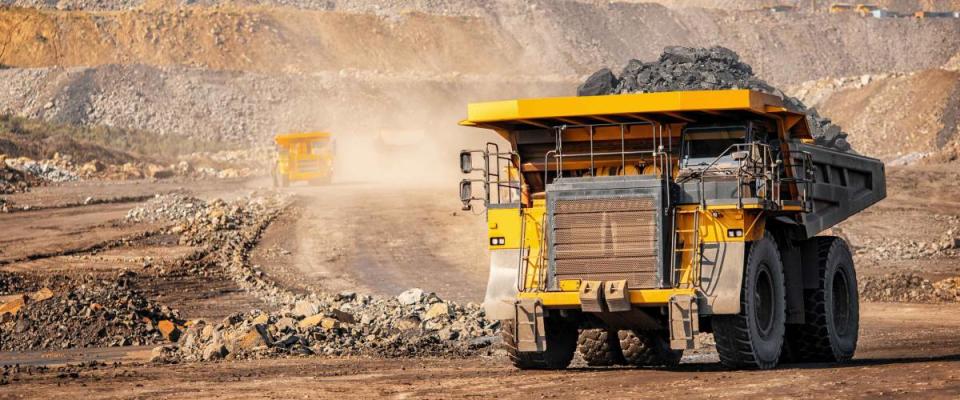 Open pit mine industry, big yellow mining truck for coal anthracite.