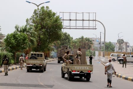 Members of UAE-backed southern Yemeni separatist forces patrol a road during clashes with government forces in Aden