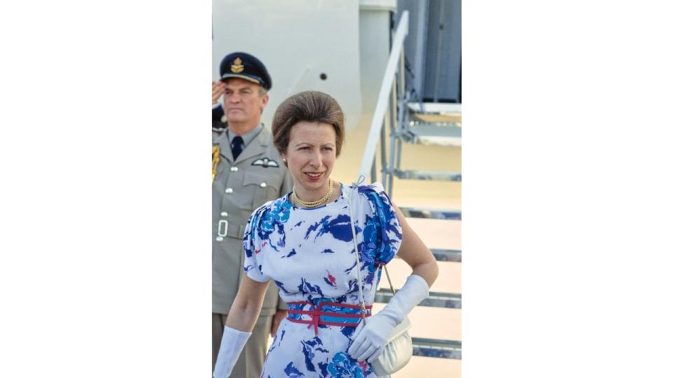 British Royal Princess Anne, Princess Royal wearing a blue and white print pattern dress with red detail, a red belt and white evening gloves during a visit to Los Angeles, California, July 1984