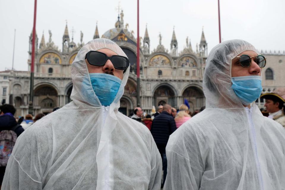 Tourists wear protective face masks at Venice Carnival (REUTERS)