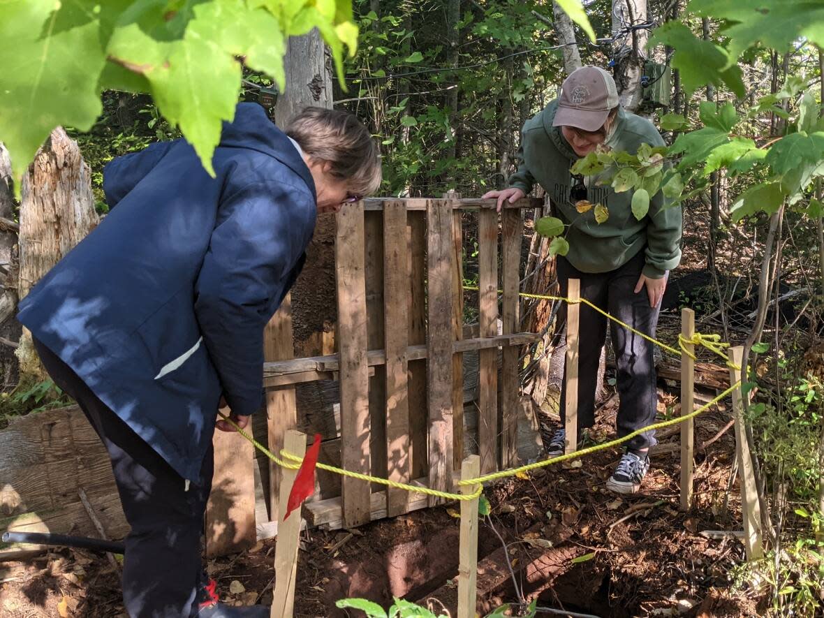 Rebecca Ramos, right, says the P.E.I. Watershed Alliance is hoping to find as many abandoned wells as possible by the end of the three-year project.   (Shane Hennessey/CBC  - image credit)