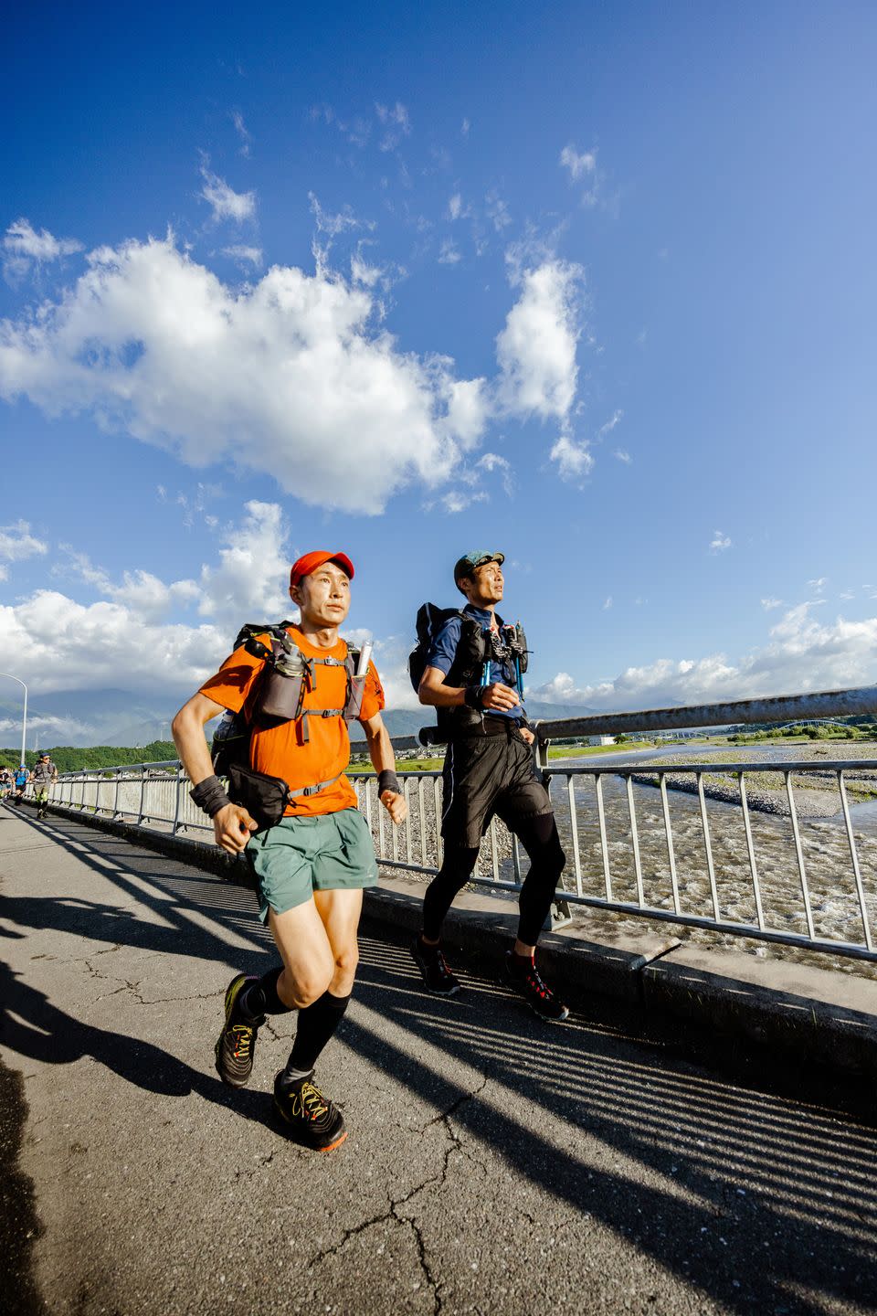 ryosuke ichinoe, left, and mitsuru mimaki cross the tenryu river during the trans japan ultra selection event