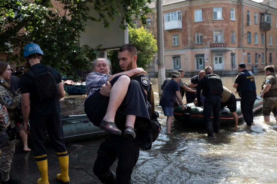 Residents are evacuated from a flooded neighborhood in Kherson, (AP)