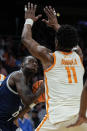 Saint Peter's guard Michael Houge (6) works under pressure from Tennessee forward Tobe Awaka (11) during the first half of a first-round college basketball game in the NCAA Tournament, Thursday, March 21, 2024, in Charlotte, N.C. (AP Photo/Mike Stewart)