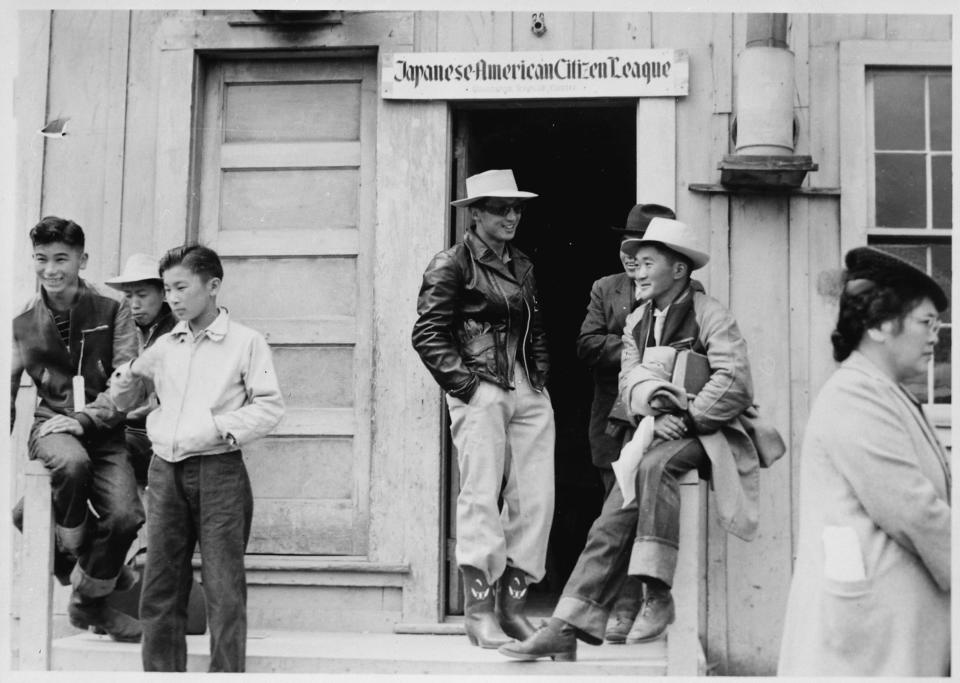 Japanese Americans waiting at evacuation meeting place