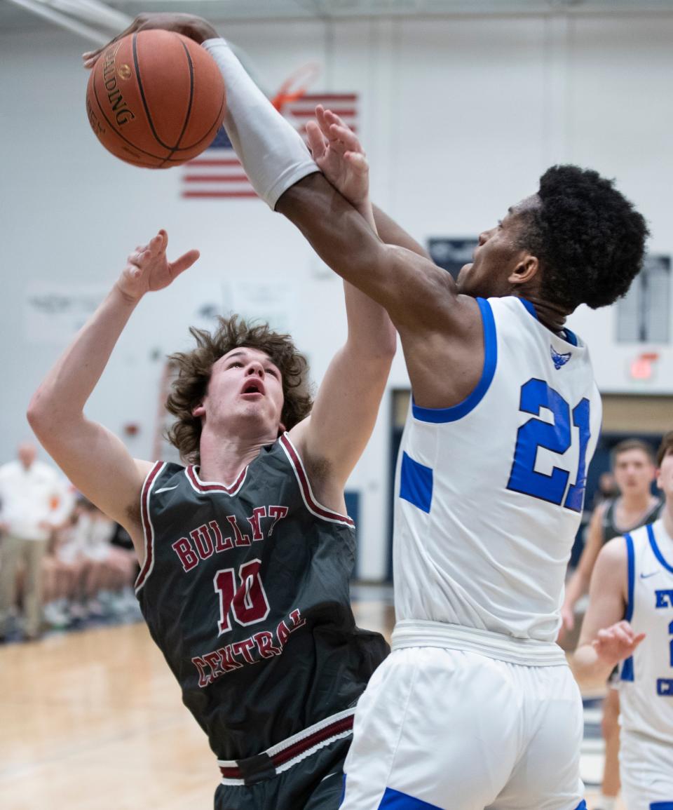 Bullitt Central's James M. Barnhard has his shot blocked by Evangel Christian's Cyr Malonga in the boys 23rd district basketball final. Feb. 25, 2022