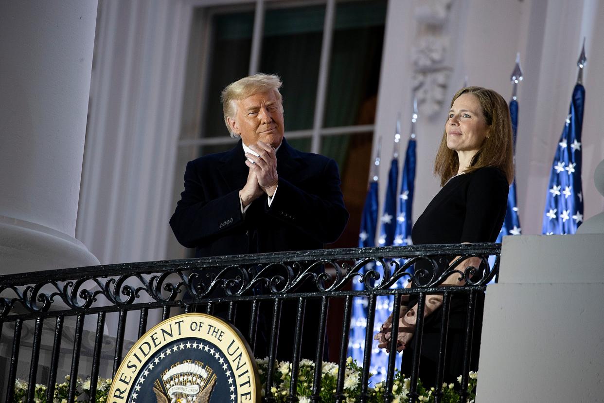 Trump stands with new US Supreme Court Justice Amy Coney Barrett during a ceremonial swearing-in event (Getty Images)