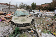 <p>Damaged cars are seen at the site of an explosion in Ningbo in China’s eastern Zhejiang province on Nov. 26, 2017. (Photo: STR/AFP/Getty Images) </p>