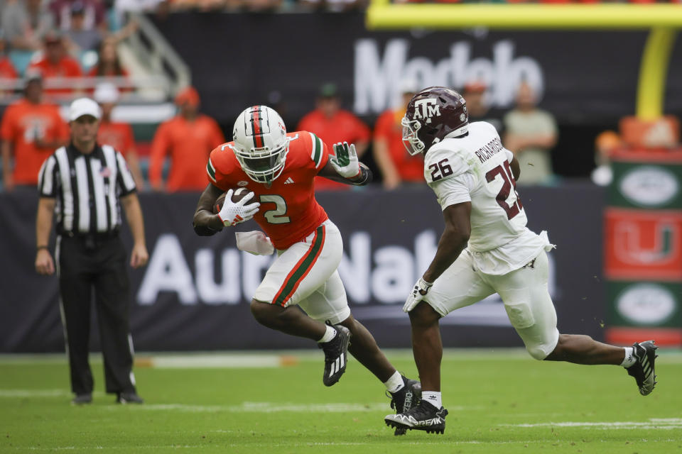 Sep 9, 2023; Miami Gardens, Florida; Miami Hurricanes running back Donald Chaney Jr. (2) runs with the football against Texas A&M Aggies defensive back Demani Richardson (26) during the second quarter at Hard Rock Stadium. Sam Navarro-USA TODAY Sports