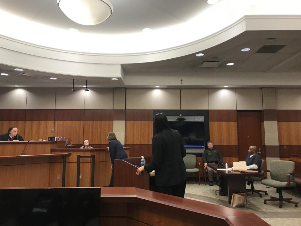 Macomb County Assistant Public Defender Joan Morgan looks at a wound on the neck of Nichole Guertin while Guertin testifies Feb. 27, 2023 during a preliminary exam in 42-2 District Court in New Baltimore. Guertin testified in the case against Arthur Williamson, seated far right, who is accused in the September 2022 slaying of former WWJ overnight anchor Jim Matthews and assault on Guertin and Matthews' and Guertin's two young children at their Chesterfield Township home.