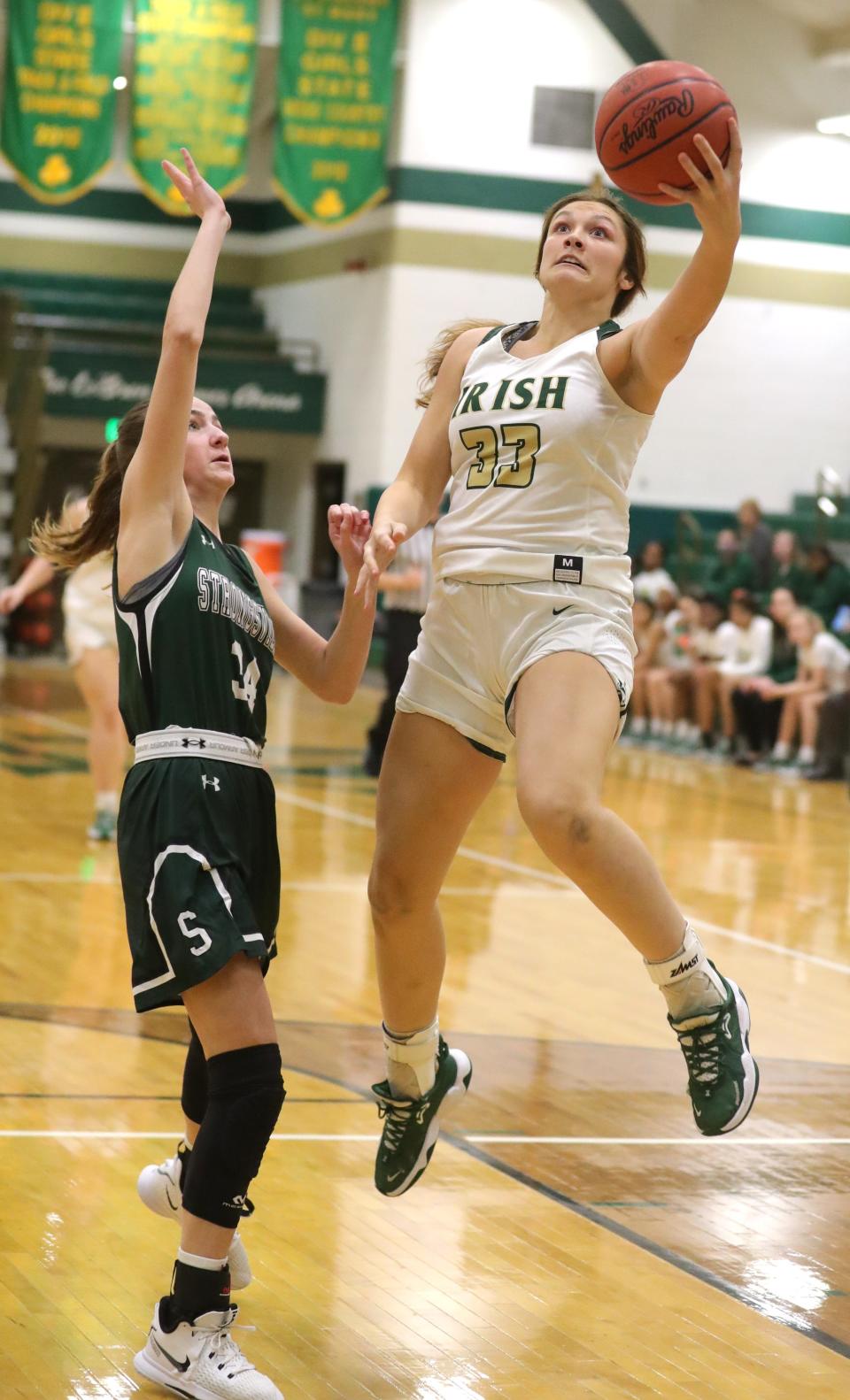 St. Vincent-St. Mary's Annie Watson drives to the basket past Strongsville's Sydney Bass during the first quarter on Thursday, Feb. 10, 2022 in Akron, Ohio, at LeBron James Arena.