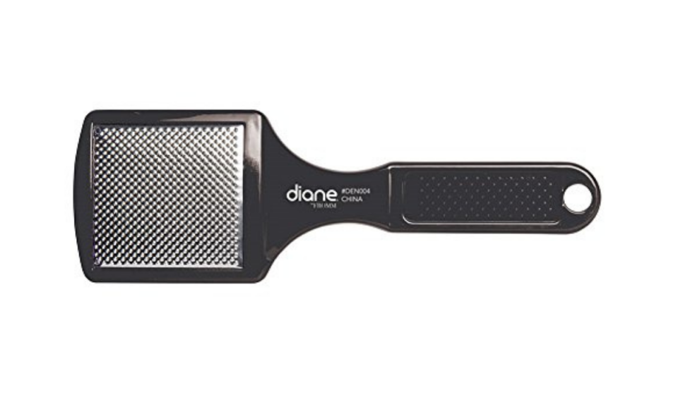 Black paddle pedicure tool with wide grater at one end. 