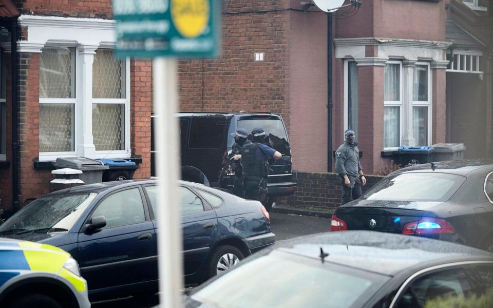 Police outside the terraced house in Willesden - Credit: Eyevine