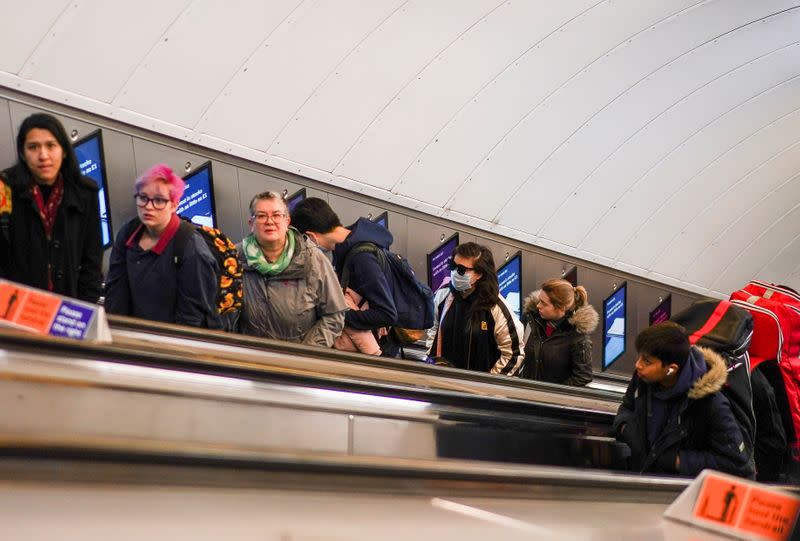 A person wears a protective face mask on the London Underground in central London