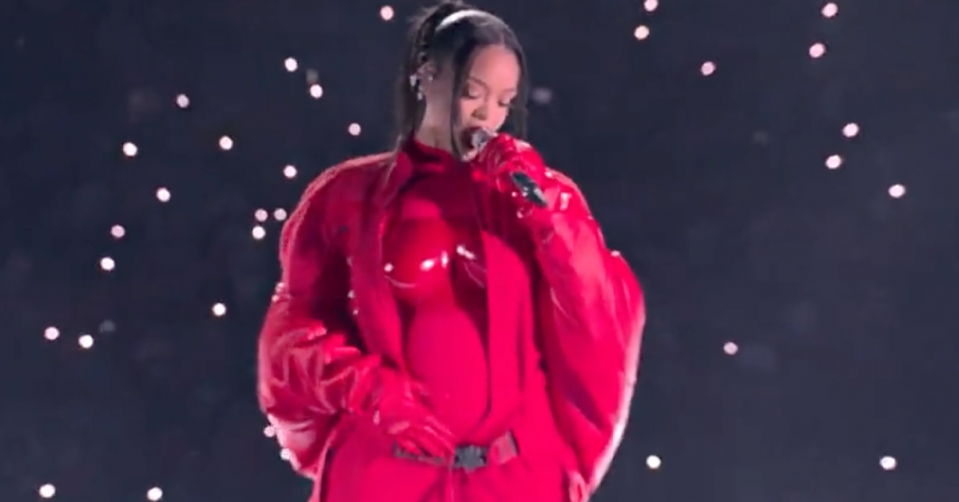 Rihanna rubs her belly during the Super Bowl halftime performance. 