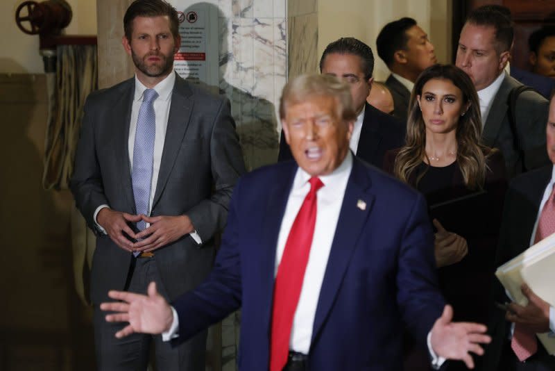 Eric Trump (L) listens as former his father and former President Donald Trump speaks while exiting the courtroom for a break at State Supreme Court on Tuesday in New York City. Photo by John Angelillo/UPI