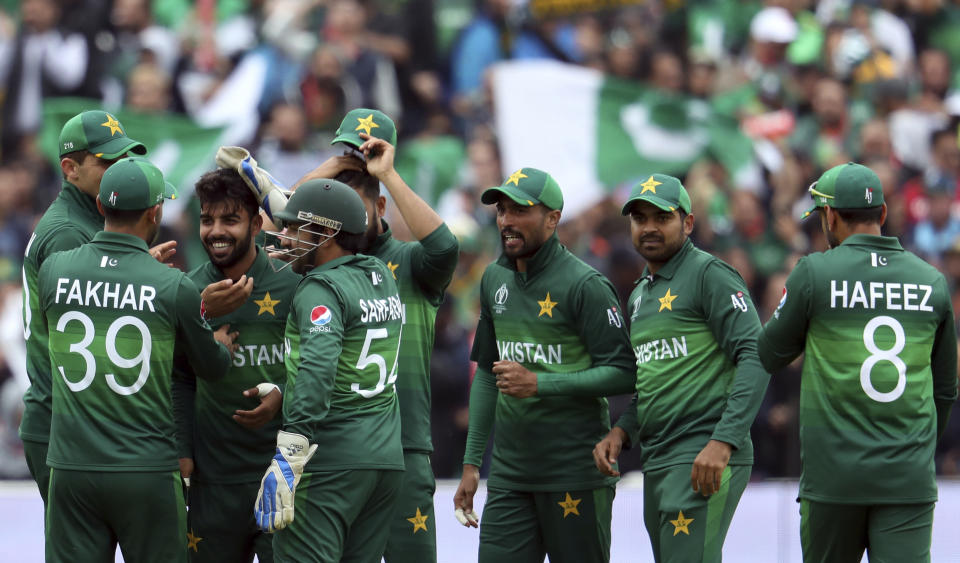 Pakistan's bowler Shadab Khan, third from left, celebrates with teammates after dismissing New Zealand's captain Kane Williamson for 41 run during the Cricket World Cup match between New Zealand and Pakistan at the Edgbaston Stadium in Birmingham, England, Wednesday, June 26, 2019. (AP Photo/Rui Vieira)