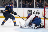 St. Louis Blues' Vladimir Tarasenko, left, shoot wide of Colorado Avalanche goaltender Darcy Kuemper during the second period in Game 4 of an NHL hockey Stanley Cup second-round playoff series Monday, May 23, 2022, in St. Louis. (AP Photo/Jeff Roberson)