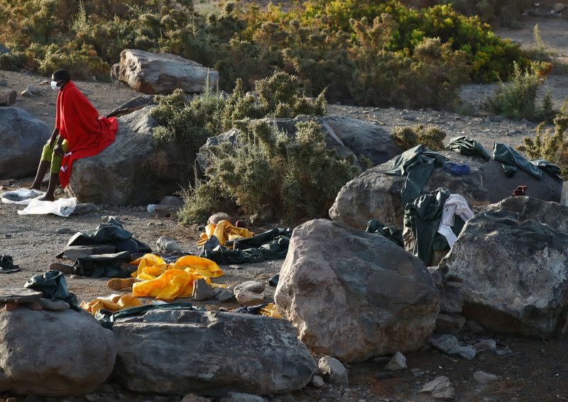 Immigrant sits at Las Carpinteras beach on the island of Gran Canaria