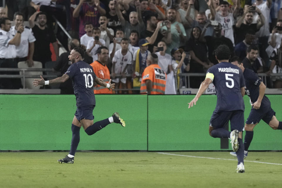 PSG's Neymar, left, celebrates after scoring his side's second goal during the French Super Cup final soccer match between Nantes and Paris Saint-Germain at Bloomfield Stadium in Tel Aviv, Israel, Sunday, July 31, 2022. (AP Photo/Ariel Schalit)