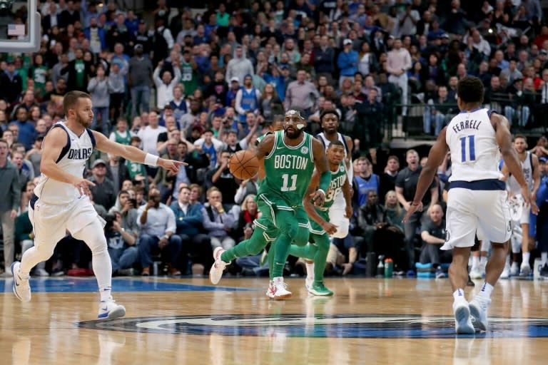 Kyrie Irving (C) of the Boston Celtics was in dazzling form as Boston rallied from a 10-point deficit to overhaul the Dallas Mavericks 110-102 in overtime