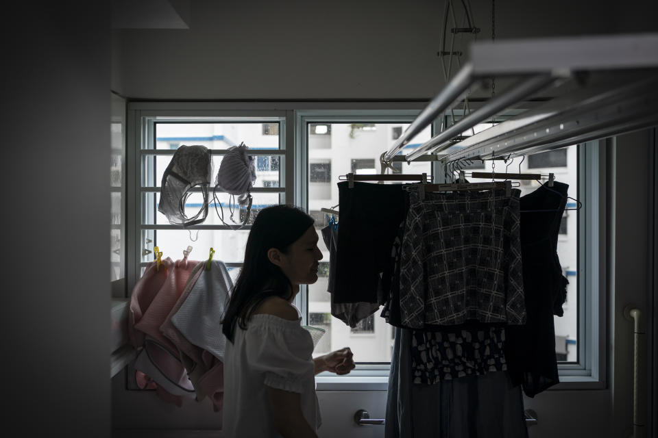 Lune Loh, 25, a transgender woman, hangs her laundry as part of her daily chores in Singapore, on Thursday, Aug. 18, 2022. In some countries, sterilization is in itself a prerequisite for legal gender recognition, explicitly spelled out in the law. In others, the wording is more vague, requiring some form of surgery without specifying what procedures are mandated or whether sterility needs to be a result. (AP Photo/Wong Maye-E)