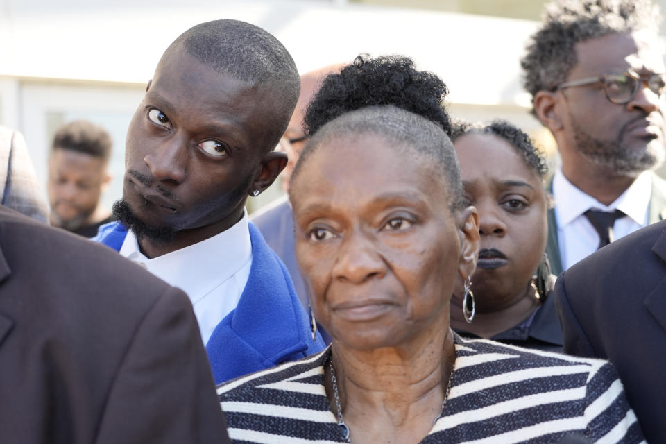 Michael Corey Jenkins, left, stands with his mother Mary Jenkins, center, outside the Thad Cochran United States Courthouse in Jackson, Miss., Tuesday, March 19, 2024, listening to reporters questions following the sentencing of the second of six former Mississippi Rankin County law enforcement officers who committed numerous acts of racially motivated, violent torture on Jenkins and his friend Eddie Terrell Parker in 2023. Sentencing continues Wednesday morning for the other four former law enforcement officers in federal court. (AP Photo/Rogelio V. Solis)