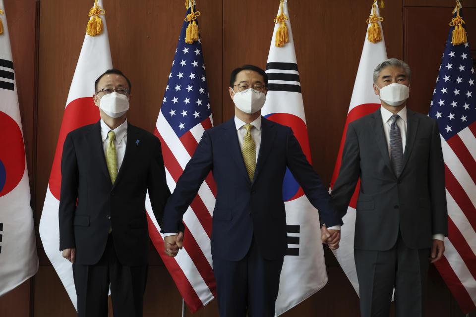 Kim Gunn, center, South Korea's new special representative for Korean Peninsula peace and security affairs, his U.S. counterpart Sung Kim, right, and Japanese counterpart Takehiro Funakoshi pose for photographs before their meeting at the Foreign Ministry in Seoul, South Korea Friday, June 3, 2022. (Kim Hong-Ji/Pool Photo via AP)