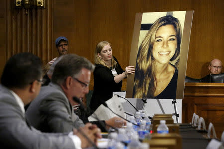 FILE PHOTO: A photo of murder victim Kate Steinle (R), allegedly killed at the hands of an undocumented immigrant, is placed on an easel as her father Jim Steinle (2nd L) prepares to testify about her murder during a hearing of the Senate Judiciary Committee on U.S. immigration enforcement policies, on Capitol Hill in Washington, DC, U.S. on July 21, 2015. REUTERS/Jonathan Ernst/File Photo