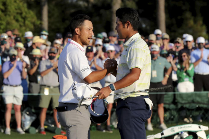 Xander Schauffele greets Hideki Matsuyama after Matsuyama won the 2021 Masters at Augusta National Golf Club on Sunday, April 11, 2021, in Augusta, Ga. (Curtis Compton/Atlanta Journal-Constitution via AP)