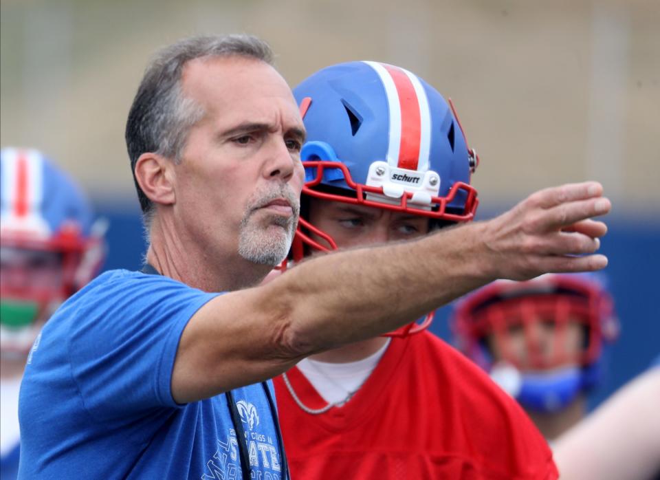 Todd Cayea, Carmel High School football coach, works with his team on the first day of practice Aug. 21, 2022.