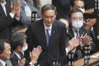 FILE - In this Sept. 16, 2020, file photo, Yoshihide Suga is applauded after being elected as Japan's new prime minister at parliament's lower house in Tokyo. Japan's new Prime Minister Suga heads to Vietnam and Indonesia on Sunday, Oct. 18, 2020, on his first overseas foray since taking over from his former boss Shinzo Abe last month. (AP Photo/Koji Sasahara, File)