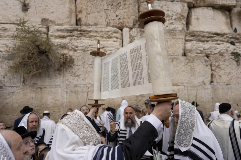 Israeli ultra-Orthodox worshippers pray during the Jewish holiday of Sukkot at the Western Wall, the holiest site where Jews can pray in Jerusalem's Old City, Wednesday, Oct. 4, 2023. (AP Photo/Ohad Zwigenberg)