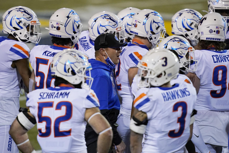 Boise State head coach Bryan Harsin, center, speaks with his players during the second half of an NCAA college football game against San Jose State for the Mountain West championship, Saturday, Dec. 19, 2020, in Las Vegas. (AP Photo/John Locher)