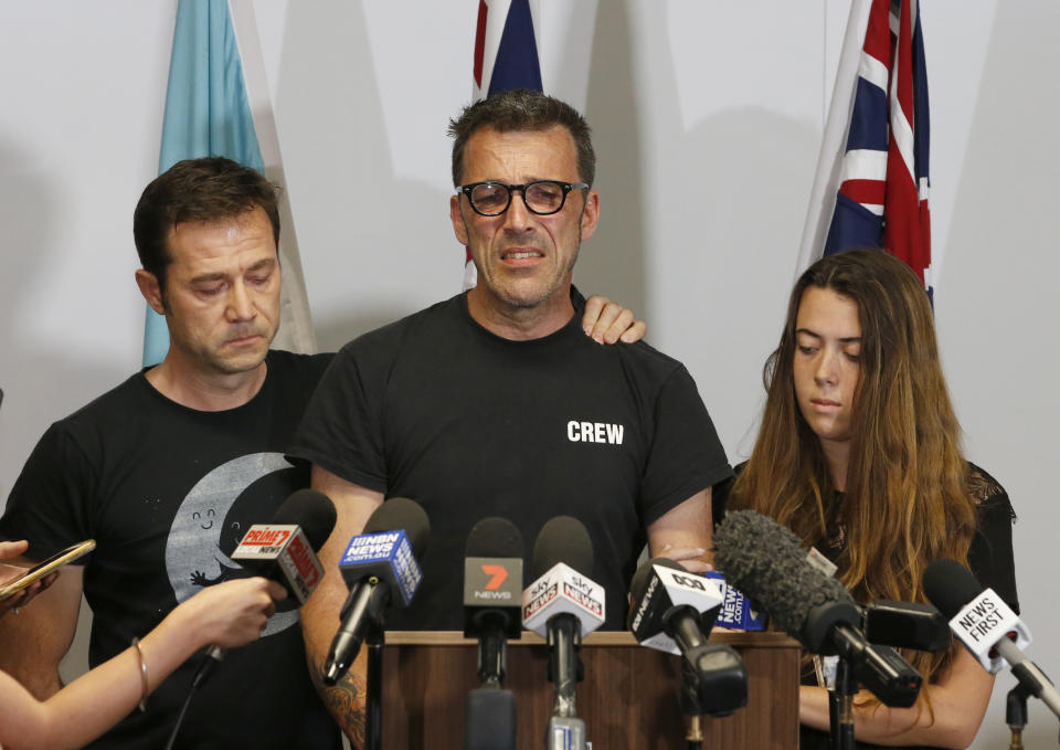 Laurent Hayez, center, father of missing Belgian backpacker Theo Hayez is joined by JP Hayez, godfather, left, and Lisa Hayez, cousin, during a public appeal for information regarding his son's disappearance, at a police station in Tweed Heads, New South Wales, Monday, June 17, 2019. Theo Hayez was last seen leaving a Byron Bay nightclub late on May 31. Police said on Monday they are baffled by the disappearance. (Regi Varghese/AAP Image via AP)
