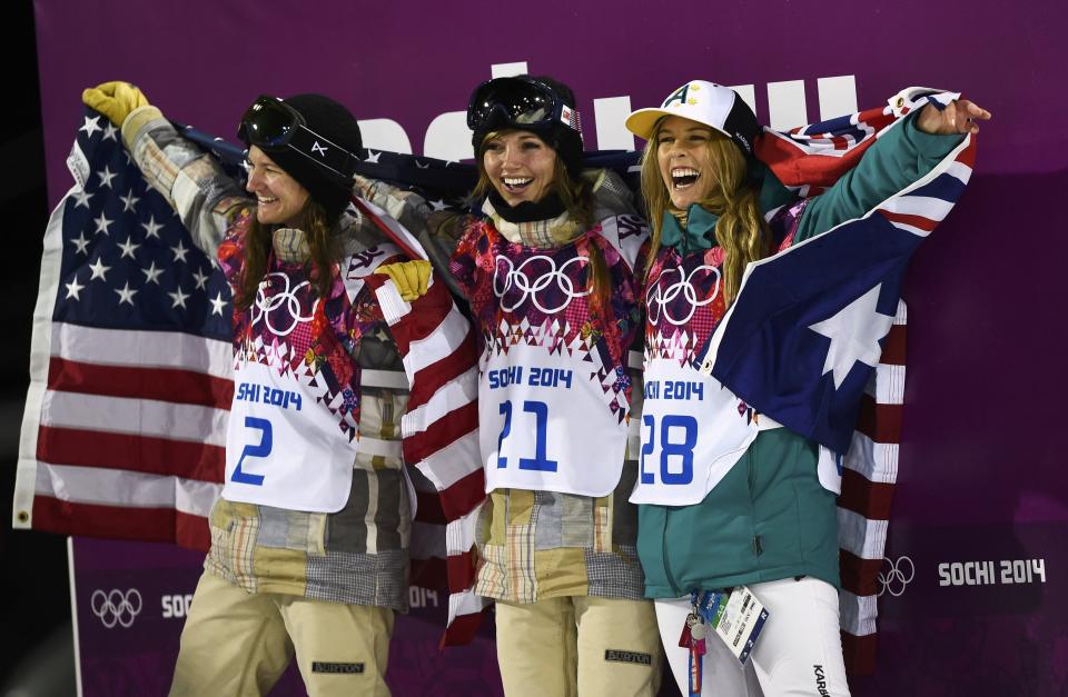 From L-R: Third-placed Kelly Clark, winner Kaitlyn Farrington, both of the U.S., with second-placed Australia's Torah Bright, celebrate with their national flags after the women's snowboard halfpipe finals at the 2014 Sochi Winter Olympic Games in Rosa Khutor February 12, 2014. REUTERS/Dylan Martinez (RUSSIA - Tags: OLYMPICS SPORT SNOWBOARDING TPX IMAGES OF THE DAY)