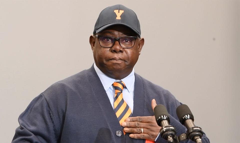 President of the York City school board Michael Breeland touches his heart while making remarks about the ten year journey out of financial recovery saying 'I cannot let our children fail.' Breeland, who is a graduate of the school district, wears his York High logo cap that he said was a symbolic gesture of his commitment to the city school district.