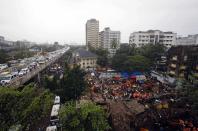 Rescue crews search for survivors at the site of a collapsed residential building in Mumbai September 27, 2013. The five-storey apartment block collapsed on Friday in the Indian financial centre of Mumbai, killing at least four people and trapping scores in the latest accident to underscore shoddy building standards in Asia's third-largest economy. REUTERS/Danish Siddiqui