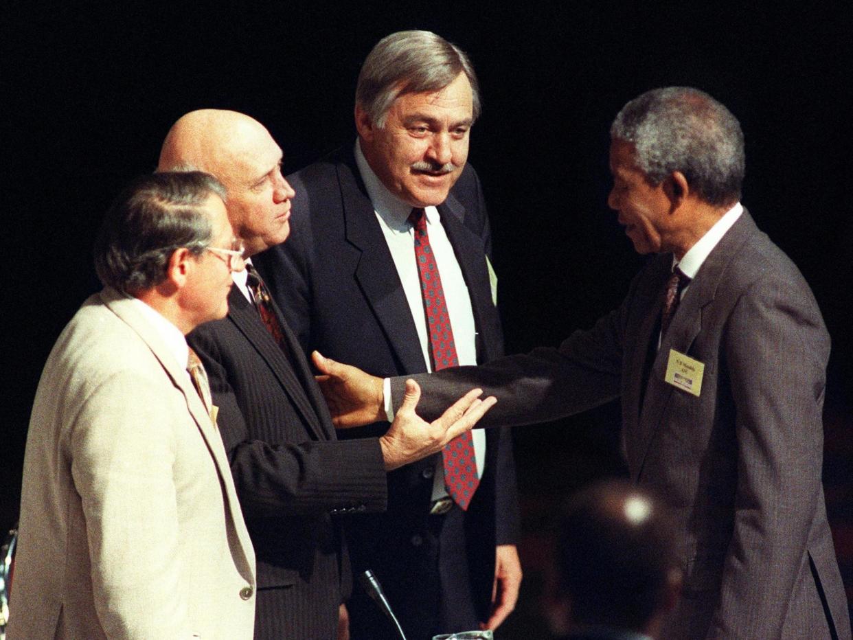 Middle man: Pik Botha between Nelson Mandela and FW De Klerk at the Convention for a Democratic South Africa in Johannesburg in 1992: Getty