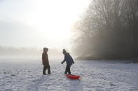 Two children drag a sledge across Knutsford Heath in Cheshire after overnight temperatures dropped below freezing. (PA Images via Getty Images)