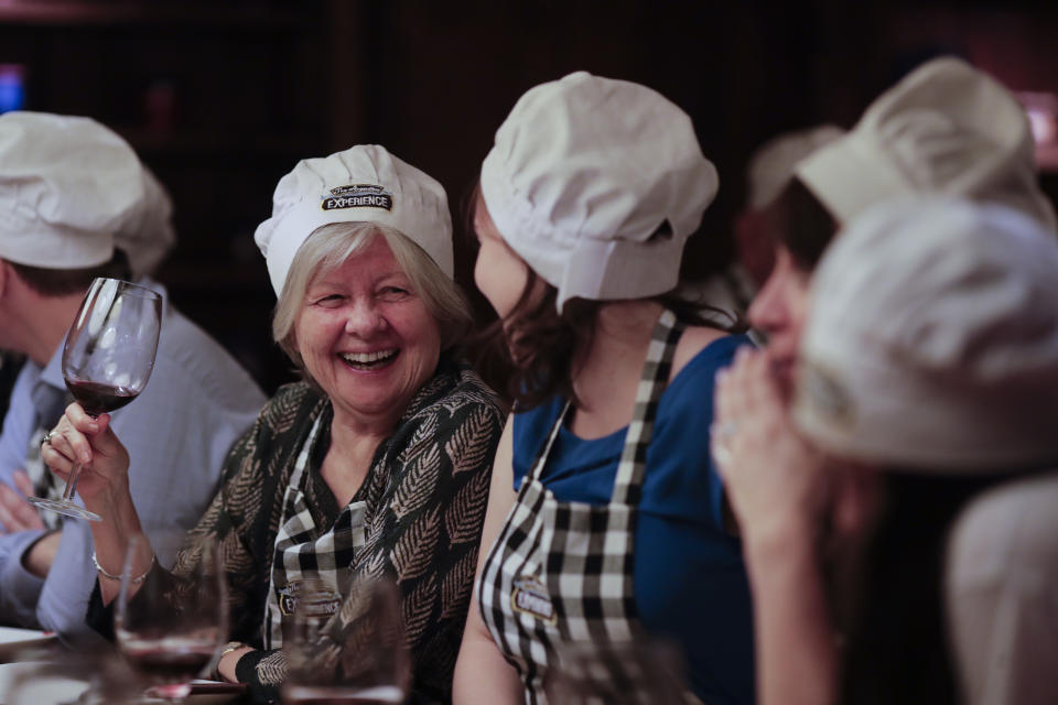 In this March 20, 2017 photo Katherine O'Connor, from Toronto, smiles during an activity called "The Argentine Experience" in Buenos Aires, Argentina. Tourists participating in "The Argentine Experience" have the chance to learn about the local cuisine, wine and traditions during a dinner in Buenos Aires. (AP Photo/Natacha Pisarenko)