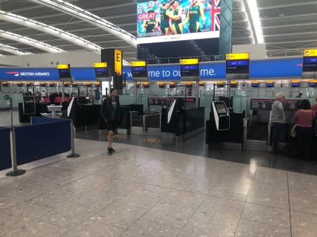 Passengers wait in Heathrow Airport as IT problems caused flight delays in London
