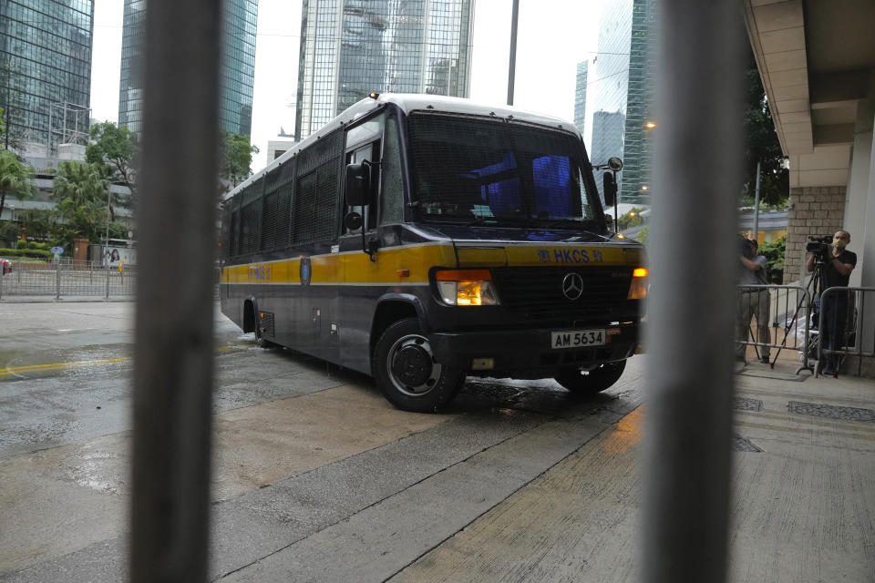 A prison van arrives as journalists wait for Tong Ying-kit's arrival at the Hong Kong High Court in Hong Kong Friday, July 30, 2021. Tong was convicted Tuesday of inciting secession and terrorism for driving his motorcycle into a group of police officers during a July 1, 2020, pro-democracy rally while carrying a flag bearing the banned slogan, "Liberate Hong Kong, revolution of our times." Tong, 24, will be sentenced Friday, the court announced. (AP Photo/Vincent Yu)