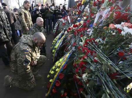 People attend a commemoration ceremony at the monument of the so-called "Nebesna Sotnya" (Heavenly Hundred), the anti-government protesters killed during the Ukrainian pro-European Union (EU) mass protests in 2014, during a rally marking the third anniversary of protests, in central Kiev, Ukraine February 20, 2017. REUTERS/Valentyn Ogirenko